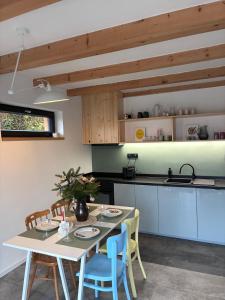 a kitchen with a table and chairs and a table and a kitchen at Chata Lipnice in Lipnice nad Sázavou
