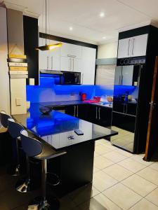 a kitchen with a blue island in the middle at The Wired Nest in Ellisras