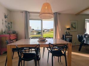 a dining room with a table and chairs and a window at Maison cosy à Gérardmer avec 2 chambres et terrasse ensoleillée, proche activités - FR-1-589-110 in Gérardmer