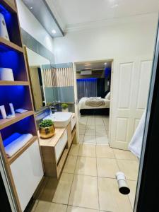 a bathroom with a sink and a bed in a room at The Wired Nest in Ellisras +55 photos