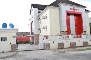 a building with a red stripe on the side of it at Charriot Hotels in Abuja