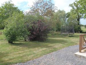 a park with a swing set in the grass at Gîte de charme avec WiFi dans ancienne ferme - FR-1-426-457 in Falleron