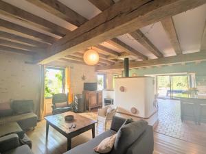 a living room with a couch and a table at Maison typique en Berry avec jardin privatif, BBQ et parking - FR-1-591-598 in Thenay