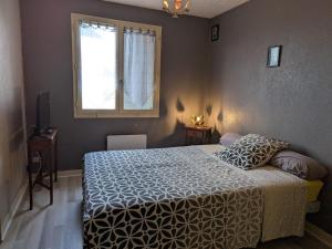 a bedroom with a bed and a window at Maison cosy à Sully-sur-Loire, 5 chambres, terrasse, parking, draps et chauffage inclus - FR-1-590-220 in Sully-sur-Loire