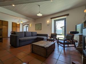 a living room with a couch and a coffee table at Élégante maison de maître XVIIIe, jardin clos 500m², nature, proche Puy-en-Velay, 11 pers., cosy & confort - FR-1-582-315 in Arsac-en-Velay
