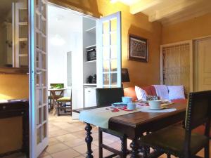 a living room with a table and a dining room at Cocon au cœur du Puy-en-Velay avec cour privée et WIFI - FR-1-582-325 in Le Puy en Velay