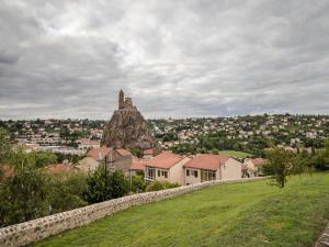 a view of a city from a hill with a castle at Cocon au cœur du Puy-en-Velay avec cour privée et WIFI - FR-1-582-325 in Le Puy en Velay
