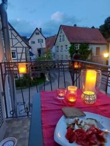 a plate of food on a table on a balcony at Tauber Lodge in Creglingen