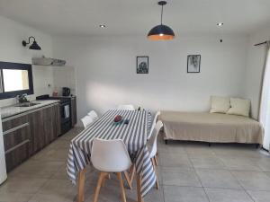 a kitchen with a table and a bed in a room at Casa Clara in Tandil