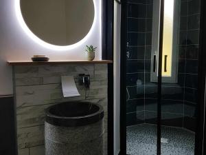 a bathroom with a tub and a shower with a mirror at Suite Familiale au Château avec Balcon sur Parc - FR-1-591-767 in Cluis