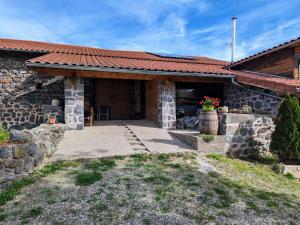 a stone house with a pathway leading to the door at Gîte confortable près de la Cascade de la Beaume avec terrasses et parking privatif - FR-1-582-30 in Solignac-sur-Loire