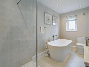 a bathroom with a bath tub and a shower at 2 Bed in Cartmel 73154 in Cartmel +6 photos
