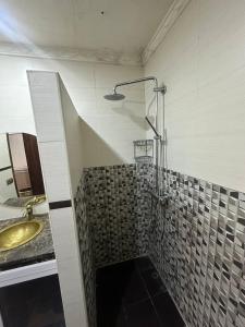 a bathroom with a sink and a shower at Abu Issa Hostel Tangier in Tangier