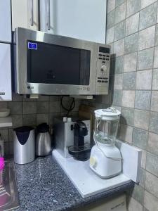 a kitchen counter with a blender and a microwave at Abu Issa Hostel Tangier in Tangier +18 photos