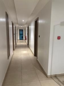a hallway of an office building with white walls and tile floors at Executive studio at East Legon in Accra +2 photos