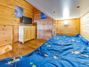圣费朗索瓦-隆尚Duplex 6 pers charme alpin, pied pistes - FR-1-807-79的一张蓝色的大床,位于带木墙的房间