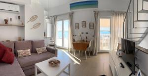 a living room with a couch and a table at Apartamentos en Paseo Maritimo in El Rompido