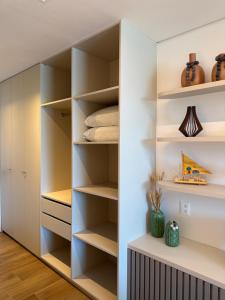 a walk in closet with white walls and shelves at Beach Class Summer in Porto De Galinhas +38 photos