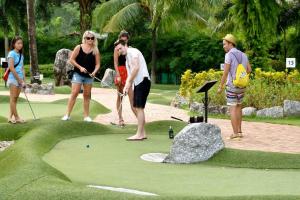 a group of people playing golf on a putting green at DANK Hotel 420 friendly Patong Phuket in Patong Beach