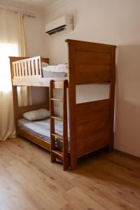 a bedroom with a bunk bed with a ladder and a bunk bed at Abu Issa Hostel Tangier in Tangier