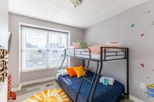 two bunk beds in a room with a window at BoardGame Bungalow in Atlantic City