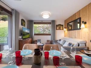 a room with a dining table with wine glasses at Confortable Appartement Familial aux Saisies avec Balcon et Parking - FR-1-809-6 in Les Saisies