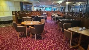 a dining room with tables and chairs on a ship at Wigan Oak Hotel by Belvilla in Wigan