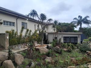 a house with a garden in front of it at Pendora Lodge Measroch and Joubert str Piet Retief in Piet Retief