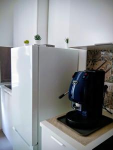 a black coffee maker sitting on a counter in a kitchen at PETER PAN apartment in Salerno +21 photos