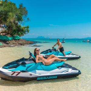 two people riding on a jet ski on the beach at DANK Hotel 420 friendly Patong Phuket in Patong Beach