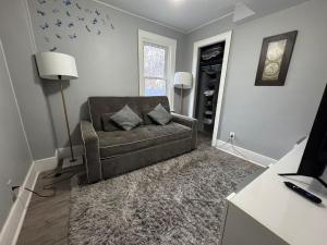 a living room with a couch and a window at 2 Bedroom Cozy Accommodation in Windsor