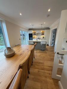 a large dining room with a long wooden table at Stylish 3-Bed Home Close to Newcastle City Centre in Kenton