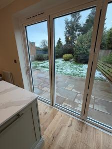 an open sliding glass door with a view of a patio at Stylish 3-Bed Home Close to Newcastle City Centre in Kenton