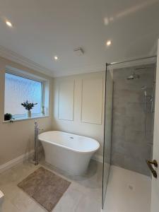 a large bathroom with a tub and a shower at Stylish 3-Bed Home Close to Newcastle City Centre in Kenton