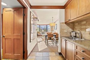a kitchen with a sink and a dining room at 6th Floor Fireplace Suite in Tahoe City