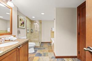 a bathroom with a sink and a toilet and a shower at 6th Floor Fireplace Suite in Tahoe City +10 photos