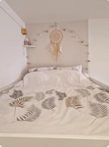 アヌシーにあるLe Petit Nid Annecyの白いベッド(白黒の掛け布団付)