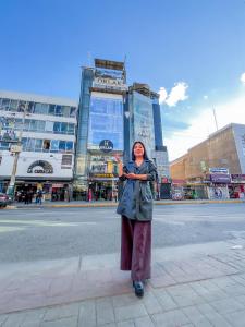 a woman standing on the side of a city street at Hotel Orlak in Huancayo