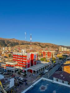 an aerial view of a city with a building at Hotel Orlak in Huancayo
