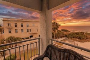 a balcony with a view of a building and the ocean at Siesta Sands Beach Resort Gulf View in Sarasota