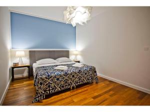 a bedroom with a bed with a blue wall at Boutique City Center View Apartments in Split