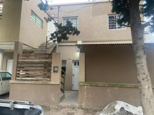 a house with a wooden fence in front of it at Alquileres Fernando in San Clemente del Tuyú
