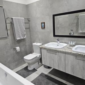 a bathroom with a toilet and a sink at Atlantis in Hentiesbaai