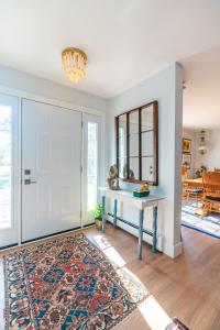 a room with a door and a table with a mirror at Blue Ocean Cove Beach House in Saint Peters