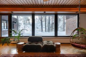 a living room with a couch and a large window at Villa Amara & Private Spa in Rovaniemi