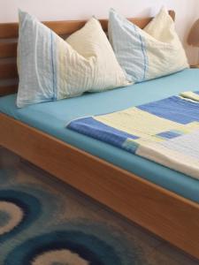a bed with pillows on top of it at Guest House Željko Klarić in Skradin