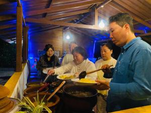 a group of people preparing food in a restaurant at Sigiriya Ranasinghe Nature Villa & Cabana in Sigiriya