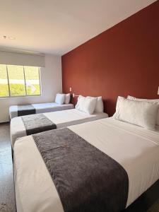 a hotel room with two beds and a wall at HOTEL RIVERA CENTRAL in Bucaramanga +17 photos