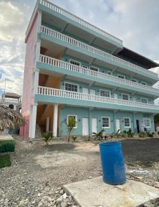 a large building with a blue barrel in front of it at Apartamento de recreación vista al mar in Boca Chica