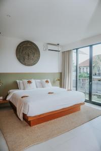a bedroom with a large bed and a large window at Villa Grazia Luxury Retreat Canggu in Canggu +121 photos